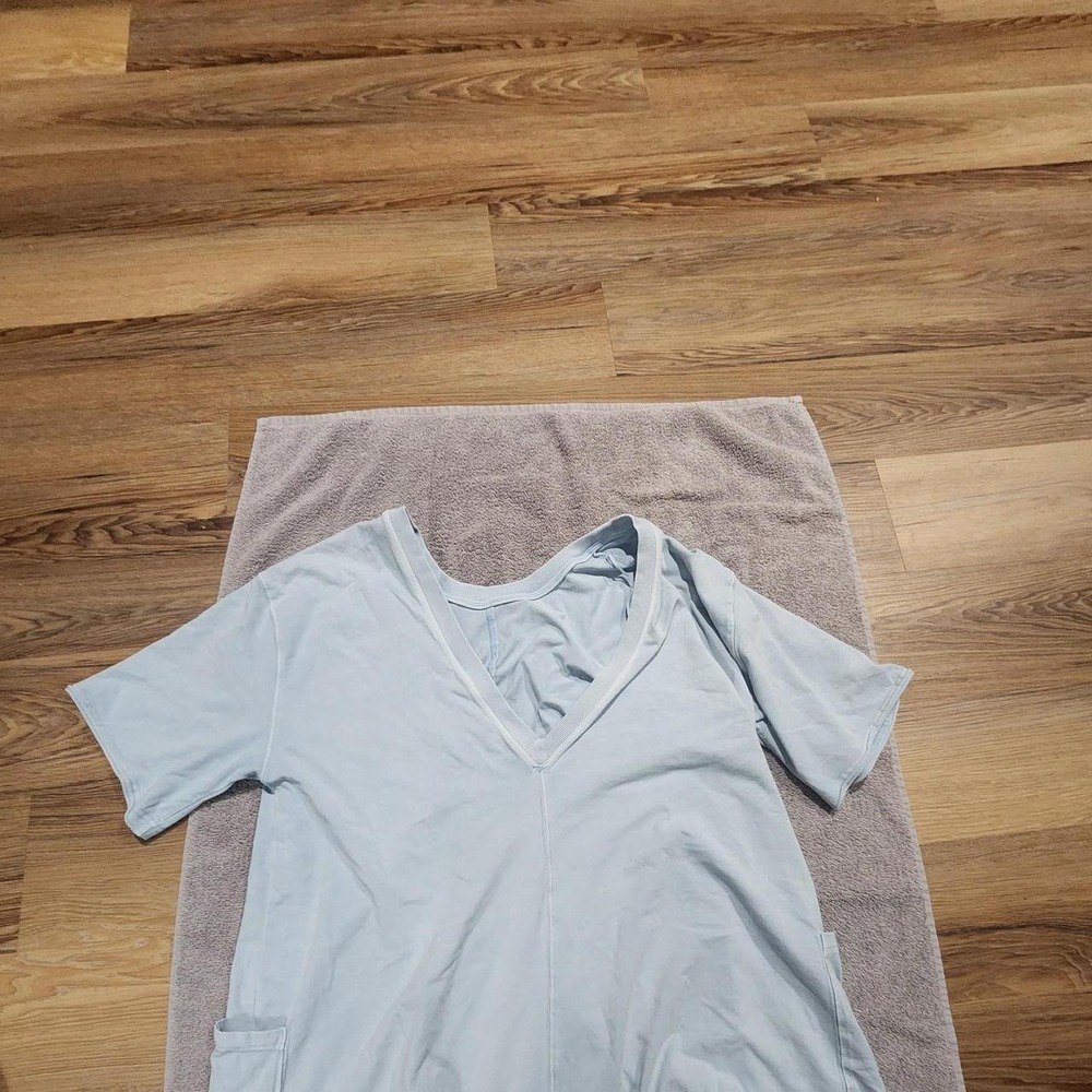 Light blue romper with pockets Free People... no tag but pit to pit is 22 inches